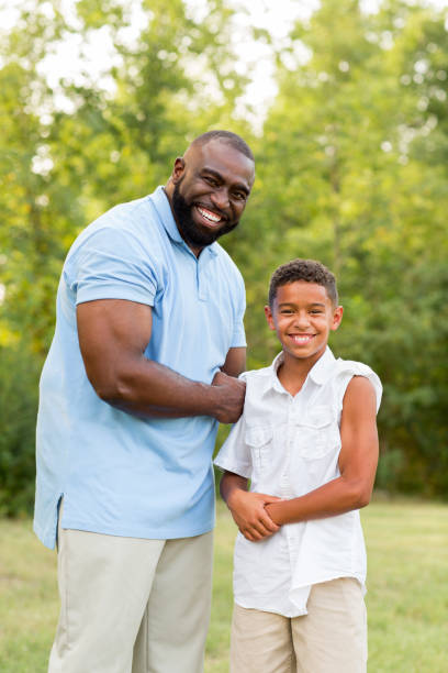 istock Father and his son flexing their biceps. 1191126257