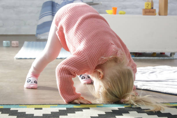 istock Two years old toddler girl learning to roll forward 1191126497