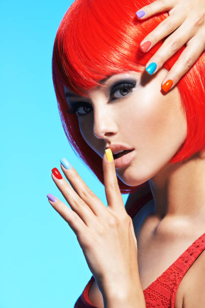 istock Portrait  of a model with red hairs and multicolor nails. 1191127176