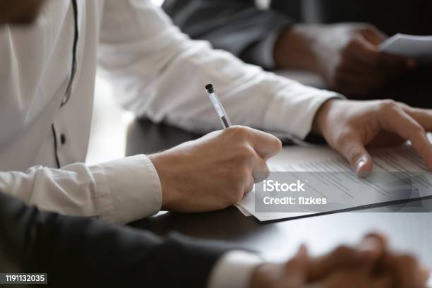 Close Up Young Male Manager Hands Signing Contract Stock Photo - Download Image Now