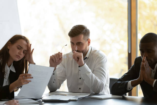 istock Mixed race frustrated group of employees feeling unmotivated. 1191132585