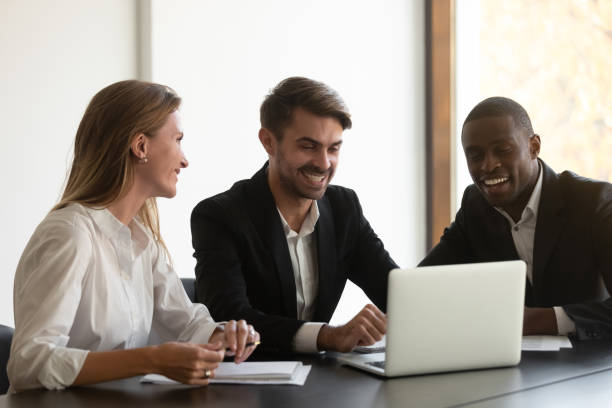 istock Smiling diverse colleagues having fun during break at office. 1191132600
