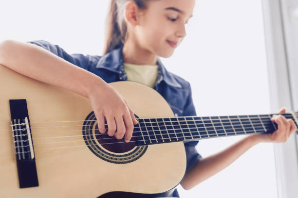 istock Girl learning to play guitar 1191133447