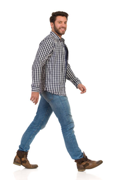 istock Walking Man In Jeans, Boots And Lumberjack. Side View 1191133506