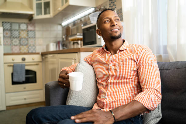 istock African man sitting at home and drinking coffee 1191133539