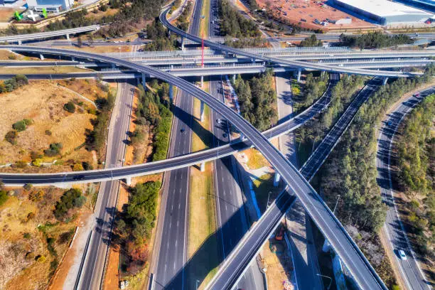 Light horse interchange between Motorways M2 and M4 in Sydney west - the most complex and multi-level intersection. Elevated aerial view over lanes, bridges and ramps.