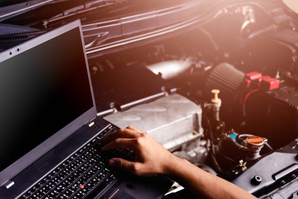 istock Professional car repair or maintenance mechanic engine working service with laptop computer 1191135487