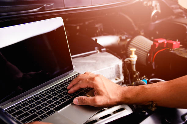istock Professional car repair or maintenance mechanic engine working service with laptop computer 1191135491