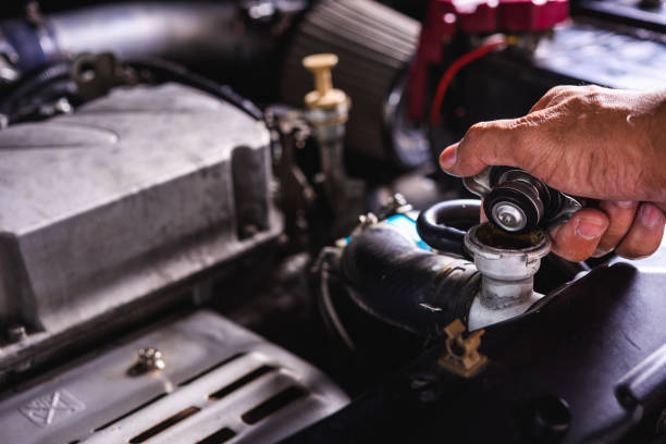 istock Hand of auto mechanic technician service check cooling water he open radiator cap 1191136407