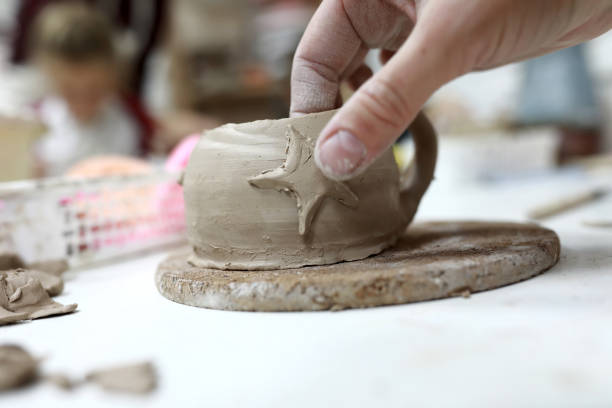 istock Person decorating clay mug 1191138574