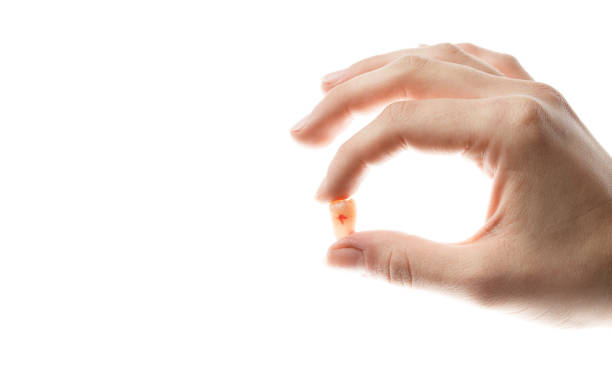 istock tooth with blood on the female palm 1191152010