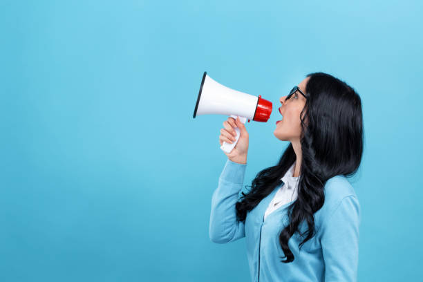 istock Young woman with a megaphone 1191152764