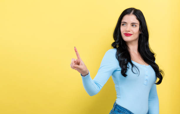 istock Young woman pointing at something 1191154705