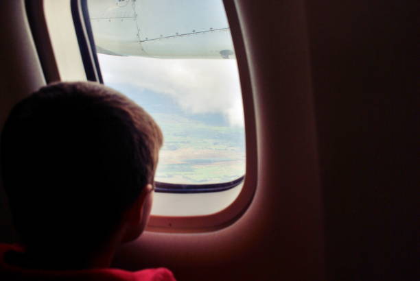 istock Child Looking out of Airplane Window 1191159007