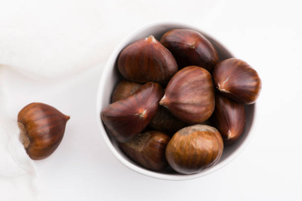 istock Bowl of chestnuts on a white background 1191161241