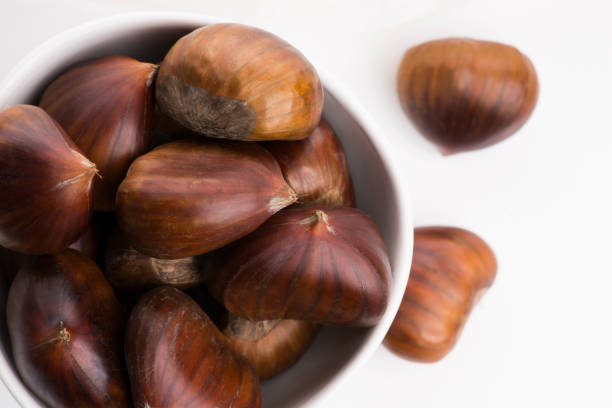 istock Bowl of chestnuts on a white background 1191161300