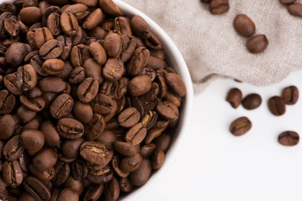 istock Bowl of caffee beans on a white background 1191161419