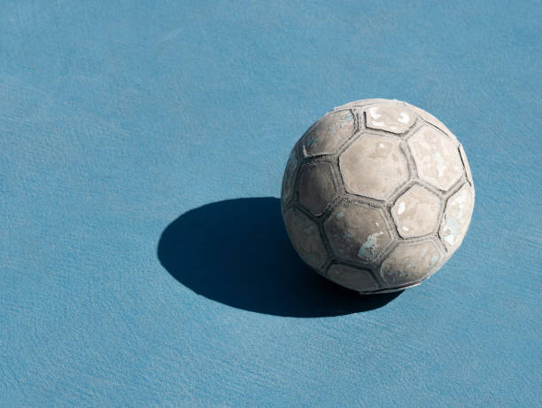 istock Old futsal ball On the blue field. 1191163215