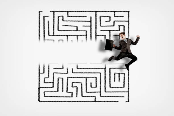 istock Businessman jumping through a maze. 1191165172