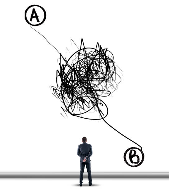 istock Businessman standing in front of a wall ,drawn with a chaotic path between point a to point b. 1191165230