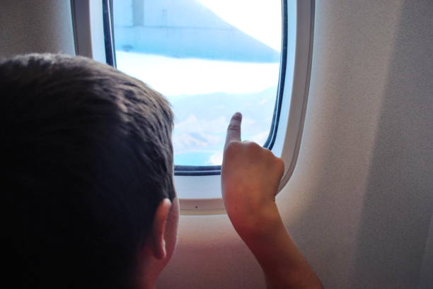 istock Child Looking out of Airplane Window 1191168004