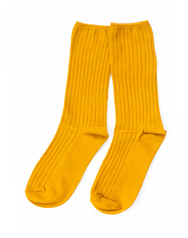 Yellow pair of socks isolated on a white background, Top view