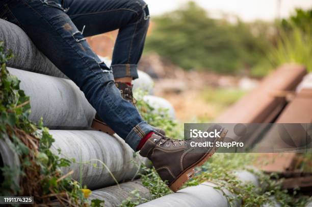 Young Fashion Model Wearing In Blue Jeans And Brown Boots Summer Clothes  Stock Photo - Download Image Now - iStock
