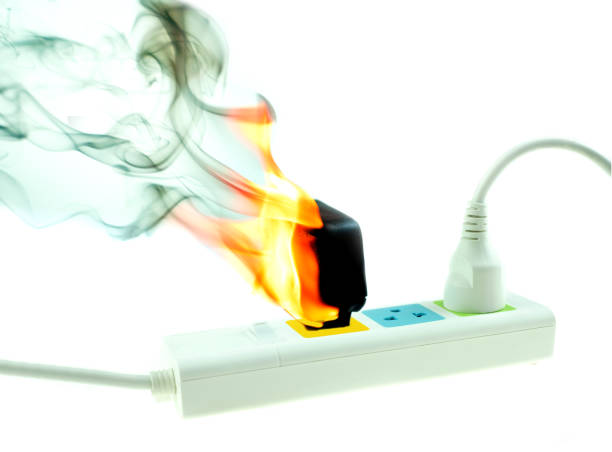 the fire is burning adapter charger plug receptacle on white background, electric short circuit failure resulting - electricity fire circuit board short imagens e fotografias de stock