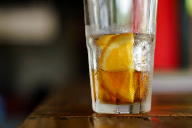 Glass of iced cold brew coffee with slice of orange