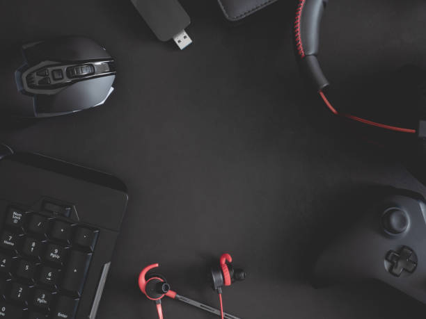 istock gamer work space concept, top view a gaming gear, mouse, keyboard, joystick, headset, mobile joystick, in ear headphone and mouse pad on black table background. 1191181418
