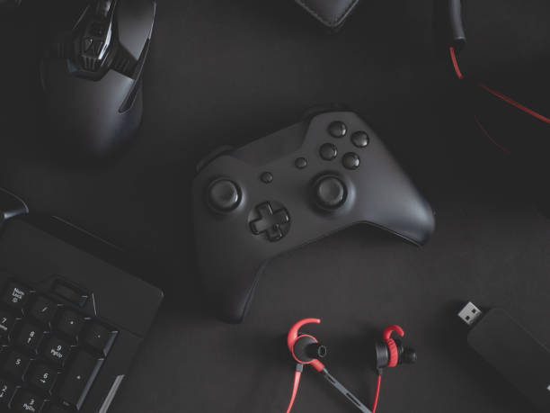 istock gamer work space concept, top view a gaming gear, mouse, keyboard, joystick, headset, mobile joystick, in ear headphone and mouse pad on black table background. 1191181441
