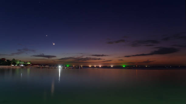 istock Sunset​ over​ the​ sea​ with​ moon and​ star 1191181457