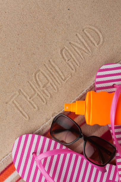 istock Word THAILAND written in sand with beach accessories. 1191185502