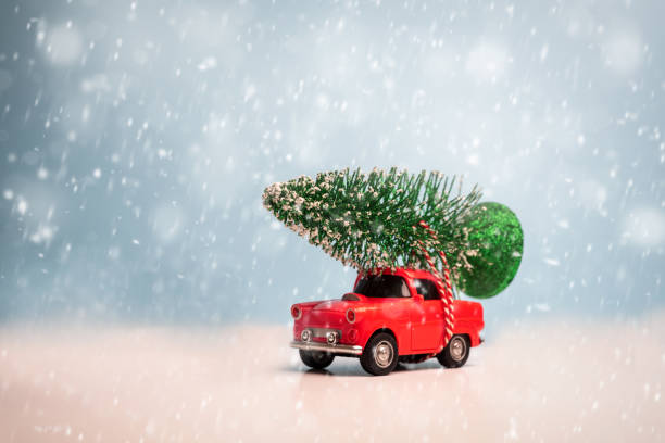 istock Red car carrying a Christmas tree 1191185712