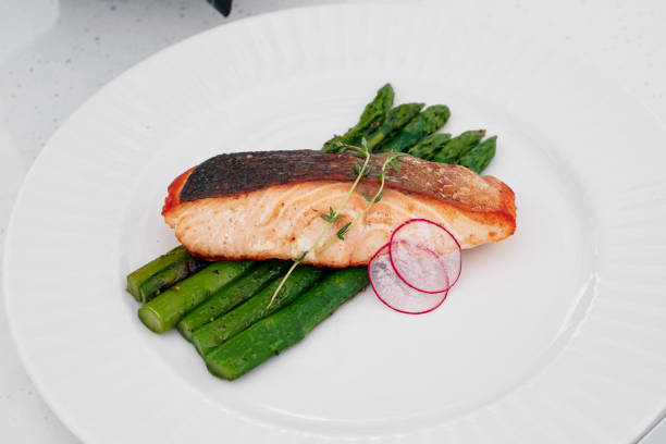 istock baked red fish and asparagus cured on a white plate 1191187828