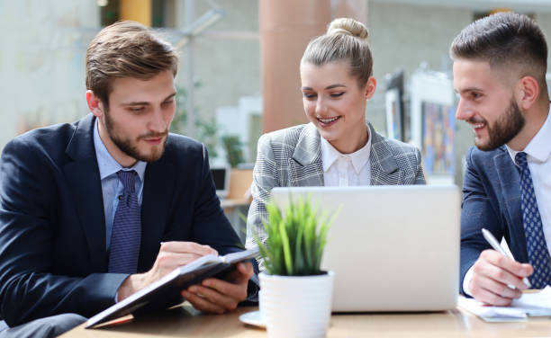 istock Group of business partners discussing ideas and planning work in office. 1191187854