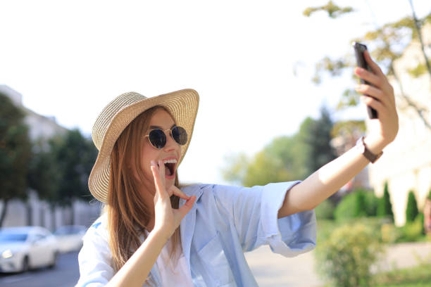 istock Beautiful young blonde girl using mobile phone while standing outdoors. 1191190986