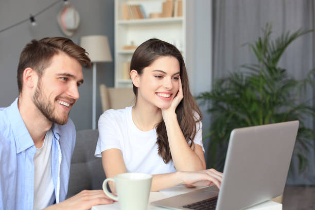 istock Couple pointing while working together on laptop. 1191191674