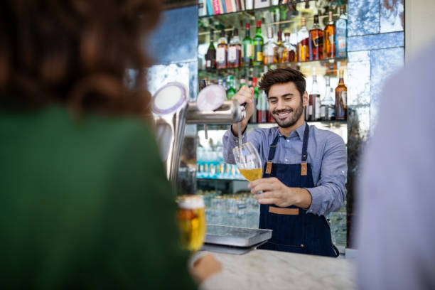 istock Bartender serving beers to the customers 1191193104
