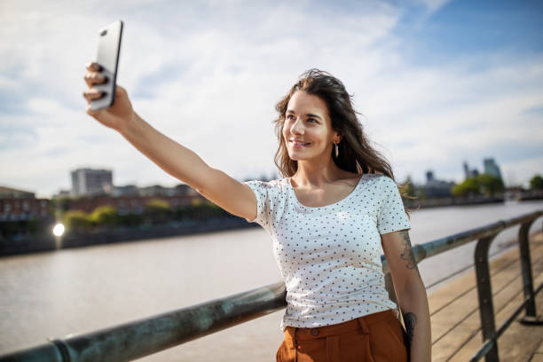 istock Beautiful woman taking selfie on the boardwalk 1191193122