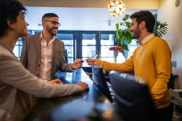 istock Businessman getting hotel room key card from reception 1191193124