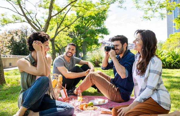 istock Man taking photos on a picnic with friends 1191193143
