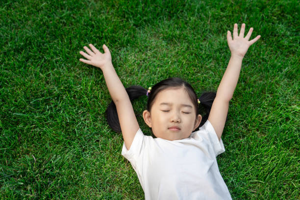 istock Cute girl lying down on the lawn 1191194128
