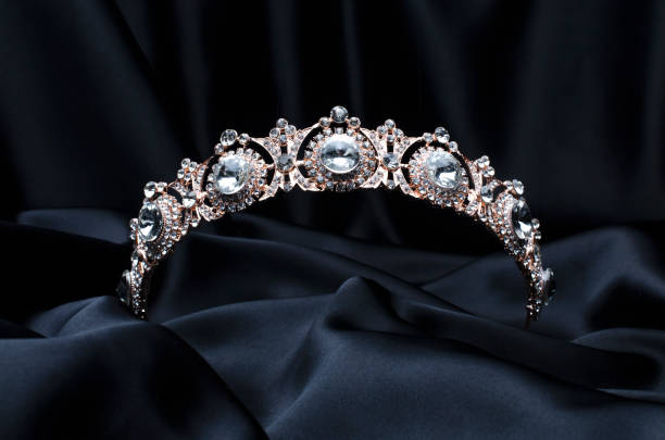 istock golden tiara with diamonds on a black silk 1191194320