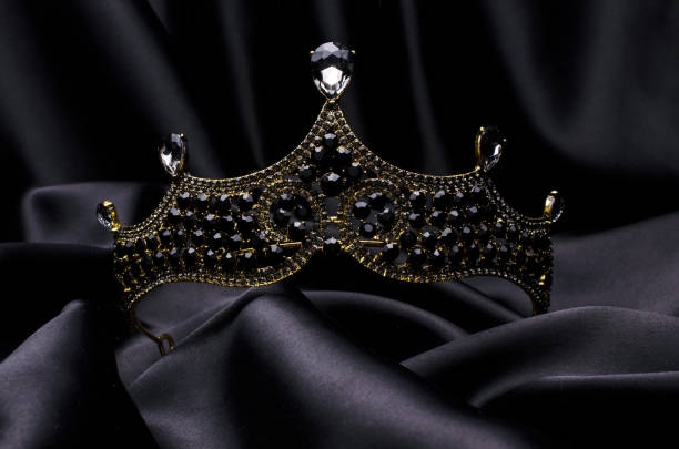 istock tiara with black stones and diamonds isolated on black silk 1191194334