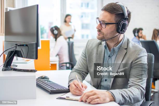 Customer Service Executive Doing Some Paperwork At Office Stock Photo - Download Image Now