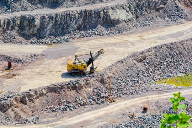 istock Big yellow excavator in the granite quarry 1191196557