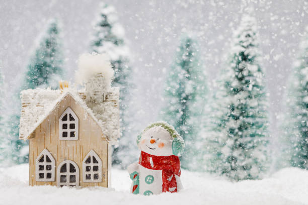 istock Snowman and house in winter 1191205294