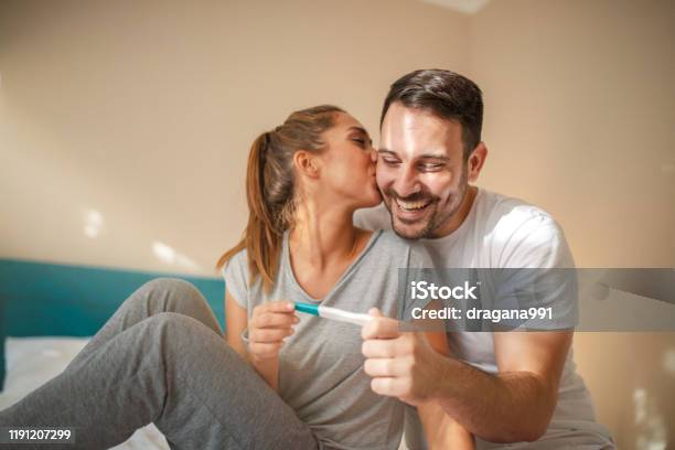 Happy Young Couple With Pregnancy Test Stock Photo - Download Image Now - Pregnancy Test, Pregnant, Couple - Relationship