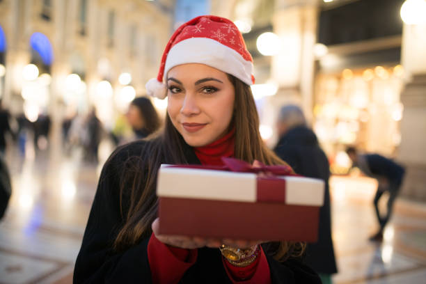 istock Young woman holding a Christmas gift 1191207576